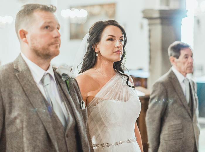 A couple standing at the altar as the service begins