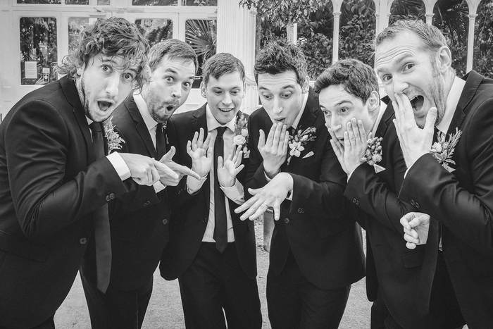 Groomsmen pulling exaggerated surprised faces for the camera